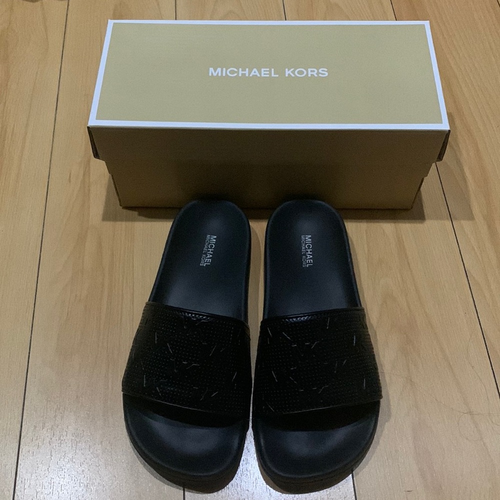 Michael Kors all black slides. They don’t fit me they are too small.